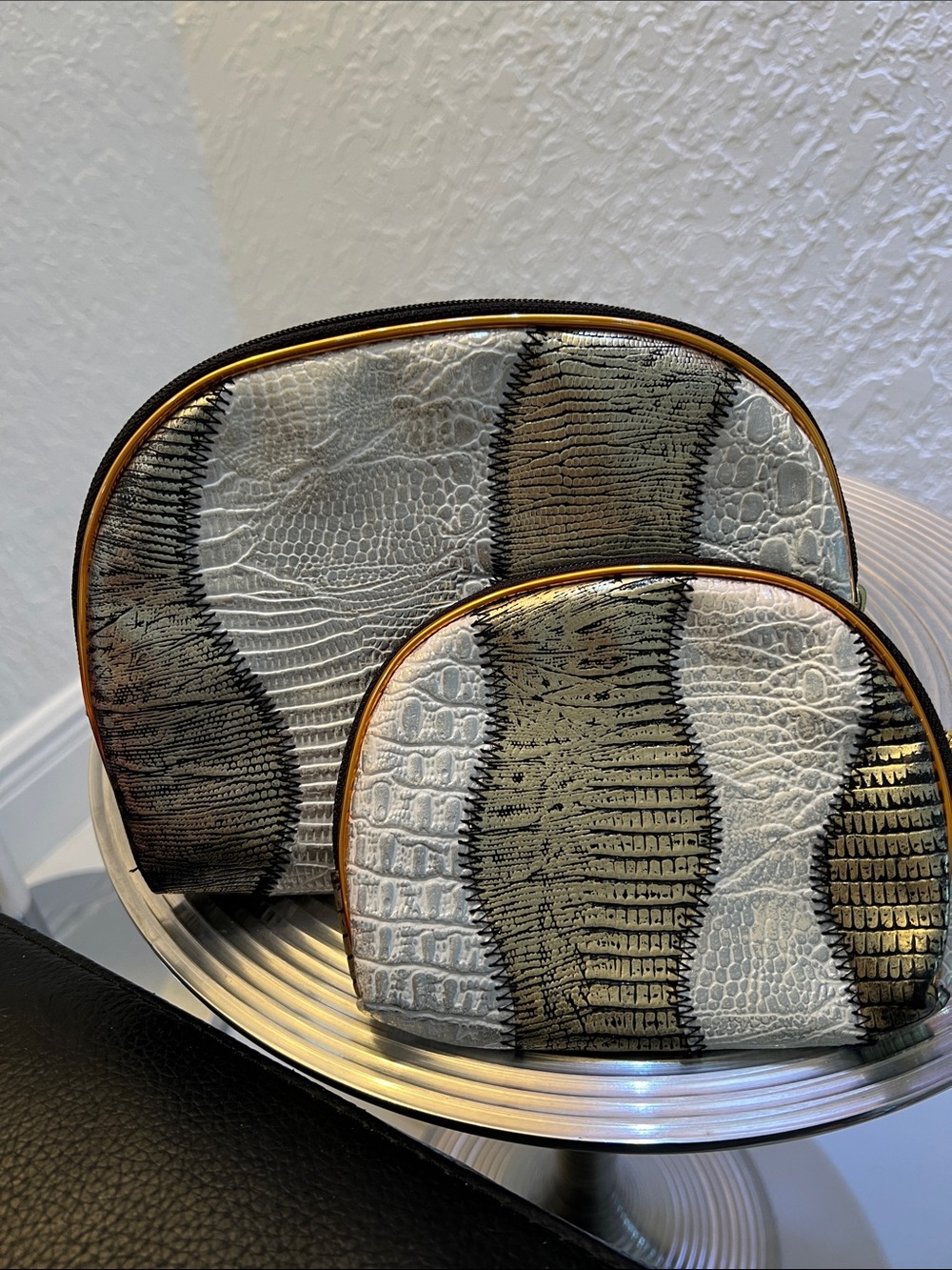 A DUO GOLD and SILVER DECORATIVE POUCH SET.